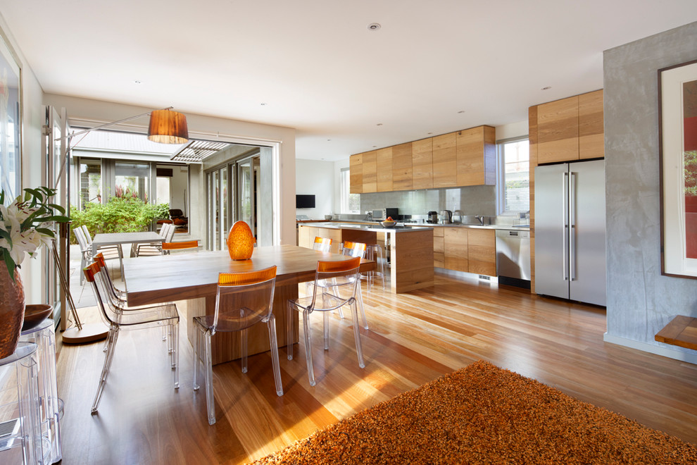 This is an example of a medium sized contemporary open plan dining room in Sydney with white walls, light hardwood flooring and brown floors.