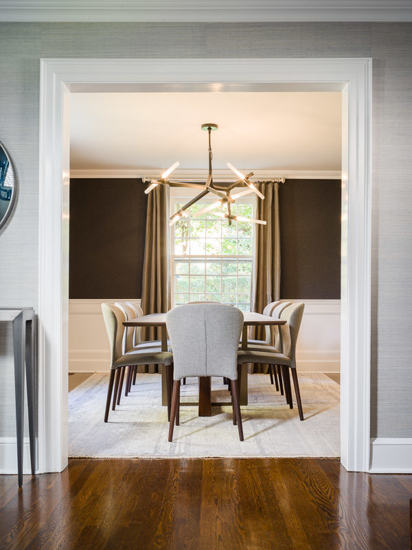 Inspiration for a mid-sized transitional medium tone wood floor enclosed dining room remodel in New York with brown walls and no fireplace