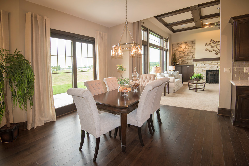This is an example of a large classic kitchen/dining room in Milwaukee with dark hardwood flooring, brown floors, beige walls and no fireplace.
