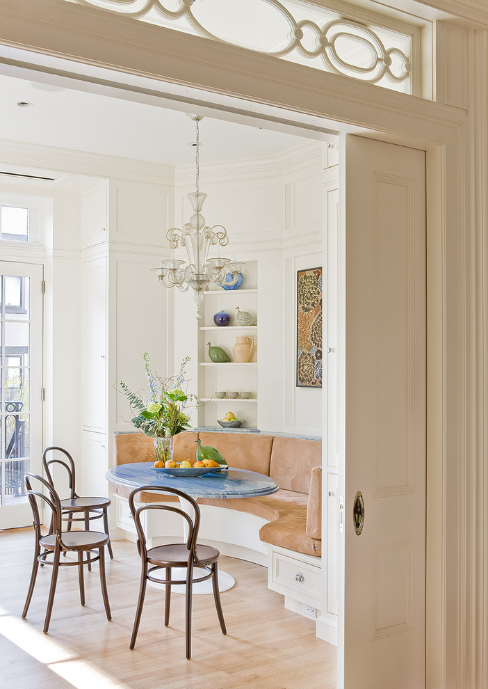 Dining room - traditional light wood floor dining room idea in New York with white walls