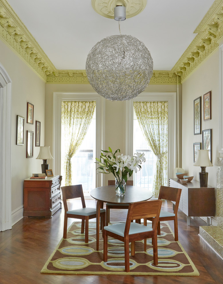 Enclosed dining room - transitional medium tone wood floor enclosed dining room idea in New York with beige walls