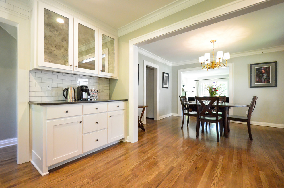 Example of a large transitional light wood floor and brown floor kitchen/dining room combo design in Kansas City with gray walls and no fireplace