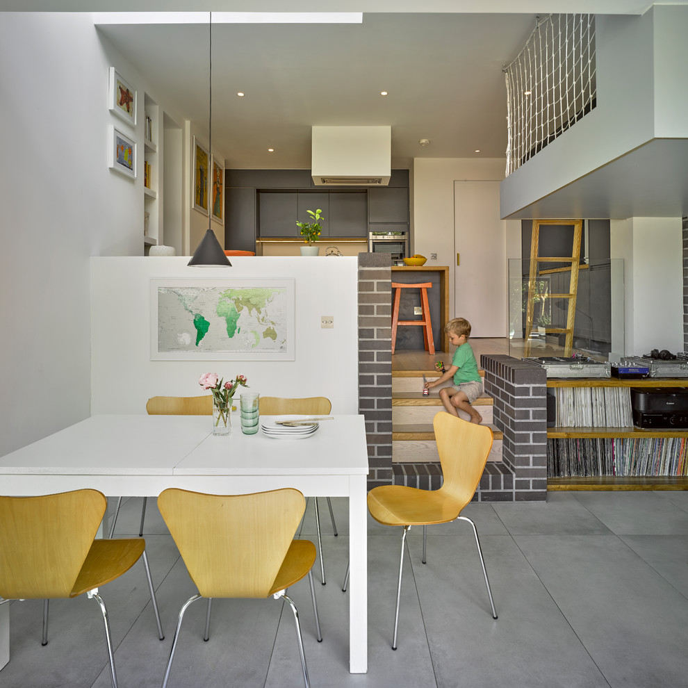 Свежая идея для дизайна: гостиная-столовая среднего размера в современном стиле с белыми стенами и серым полом - отличное фото интерьера