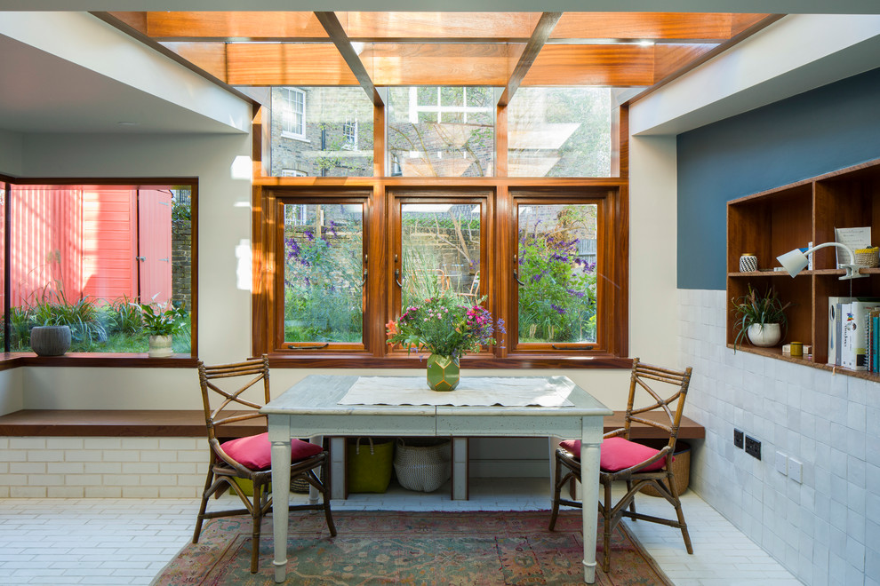 Photo of a small traditional dining room in London with beige walls, no fireplace and white floors.