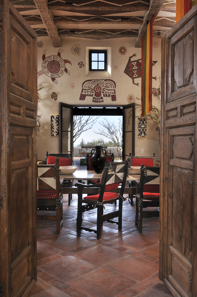 Idée de décoration pour une salle à manger sud-ouest américain avec un mur beige, tomettes au sol et un sol rouge.