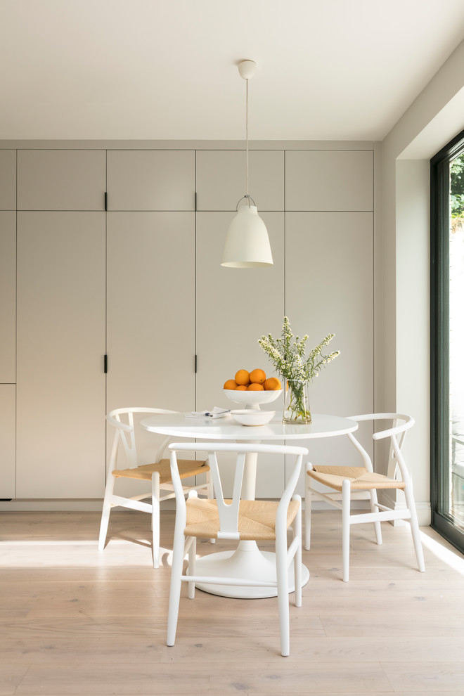 На фото: кухня-столовая среднего размера в скандинавском стиле с светлым паркетным полом, белым полом и серыми стенами