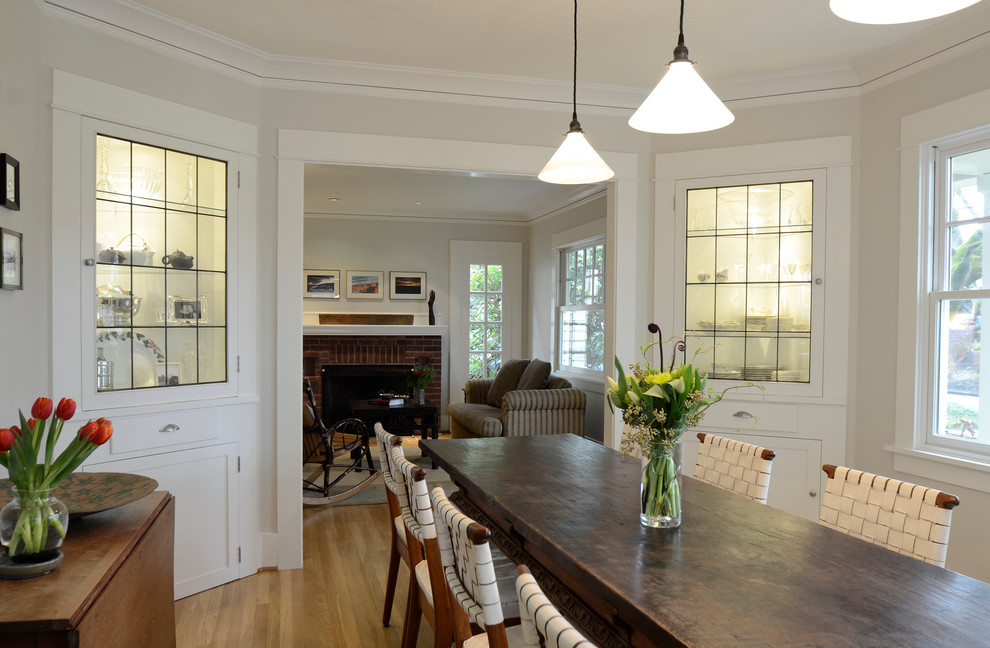 Classic dining room in Portland with grey walls and medium hardwood flooring.