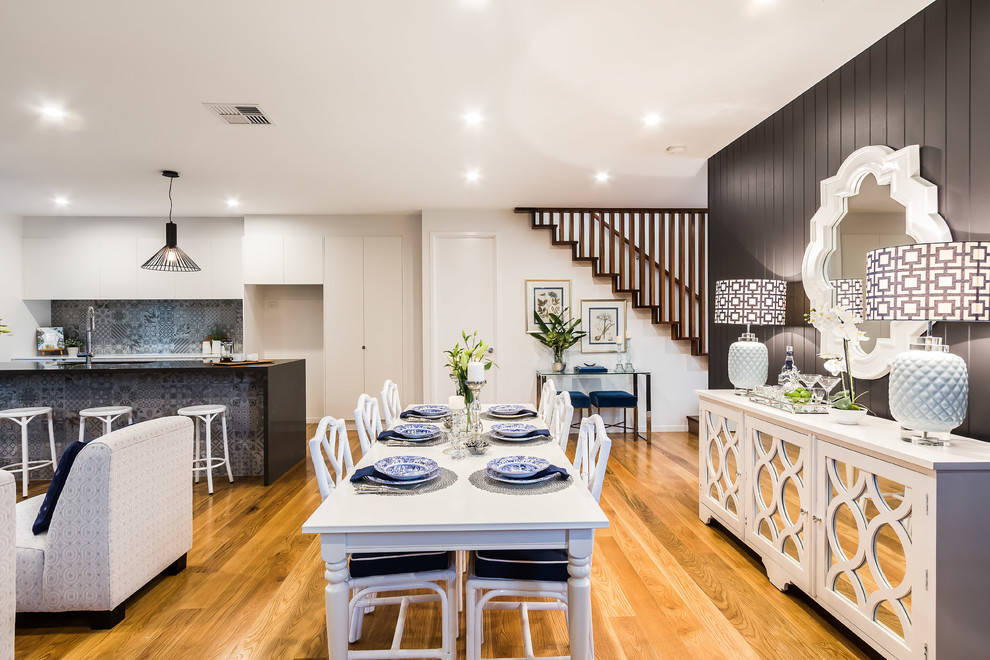 Example of a mid-sized trendy light wood floor kitchen/dining room combo design in Brisbane with gray walls