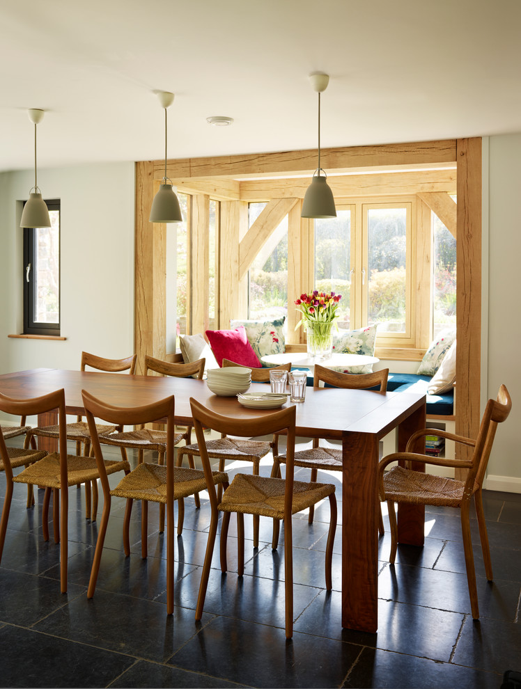 Country dining room photo in Devon with white walls