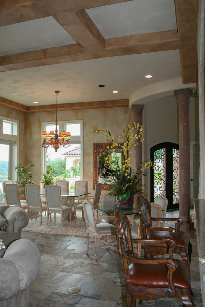 Design ideas for a large mediterranean open plan dining room in Austin with white walls, marble flooring, a standard fireplace, a stone fireplace surround and white floors.