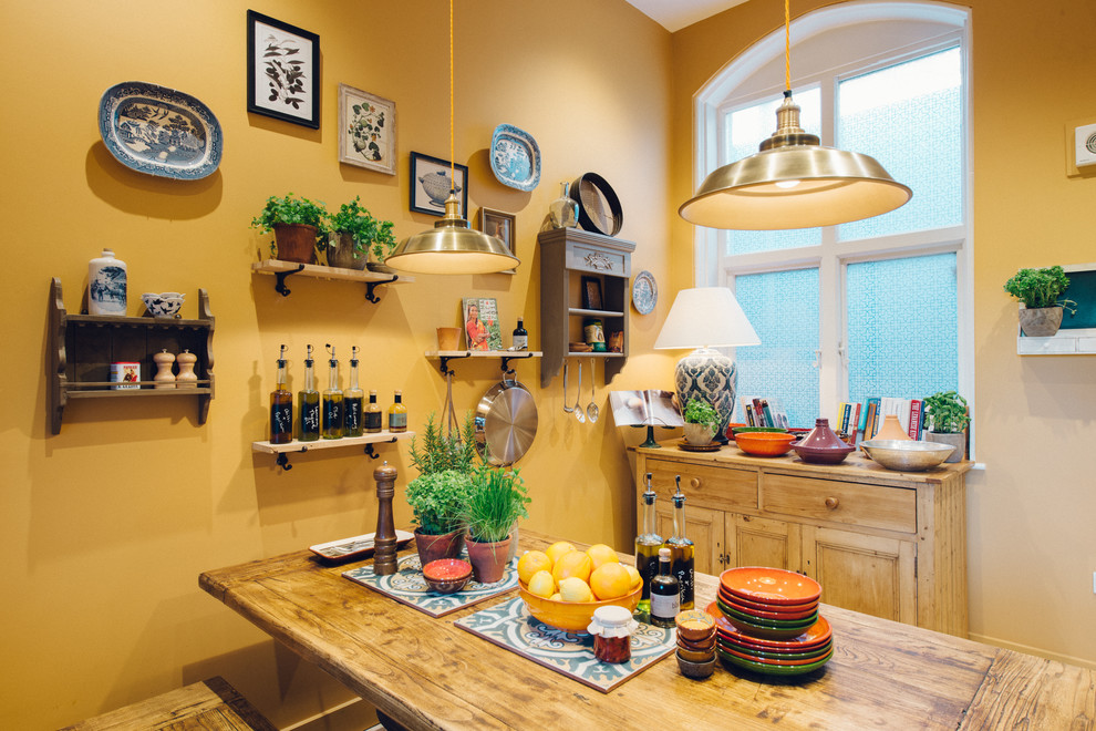 Cette image montre une salle à manger traditionnelle avec un mur jaune.