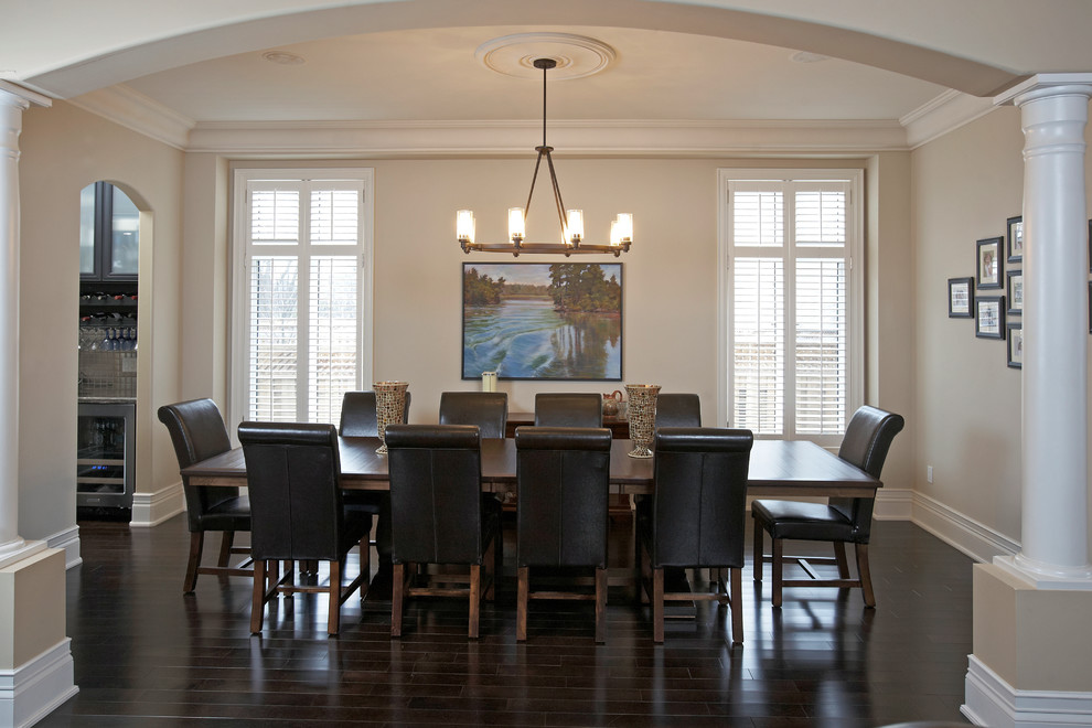 Example of a mid-sized transitional dark wood floor great room design in Toronto with beige walls and no fireplace