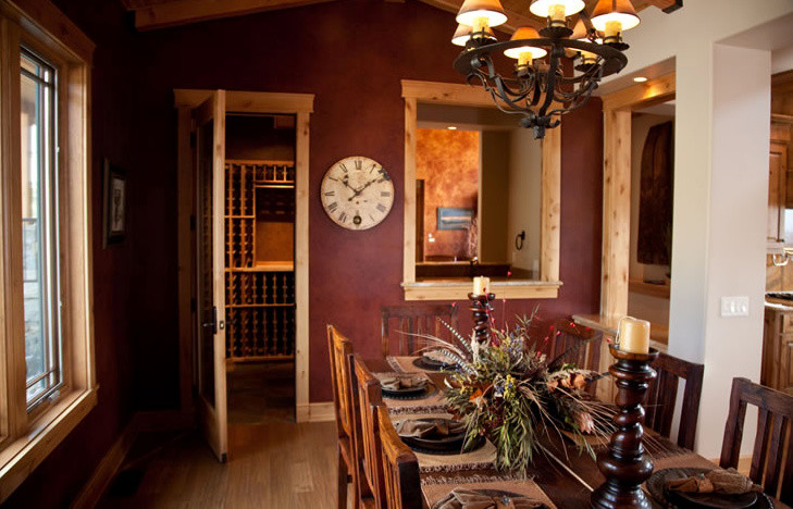 Inspiration for a mid-sized rustic light wood floor enclosed dining room remodel in Other with red walls