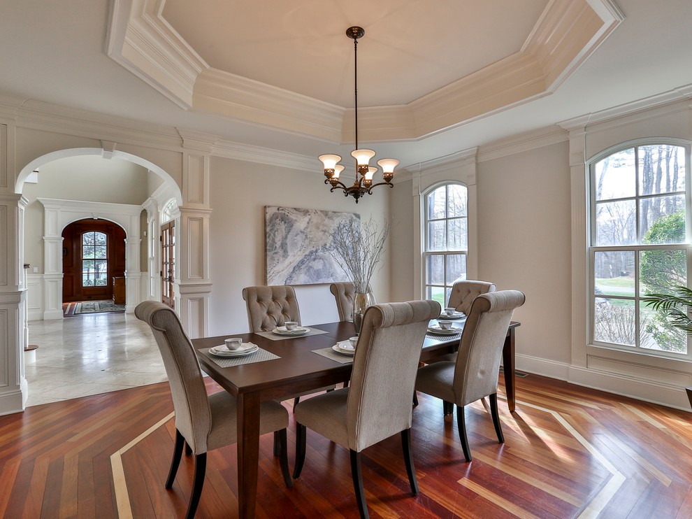 Design ideas for a medium sized traditional enclosed dining room in New York with grey walls and medium hardwood flooring.