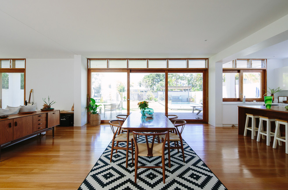 Inspiration for a coastal medium tone wood floor great room remodel in Gold Coast - Tweed with white walls