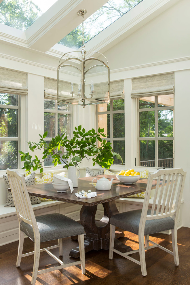 This is an example of a classic dining room in Minneapolis with white walls and dark hardwood flooring.