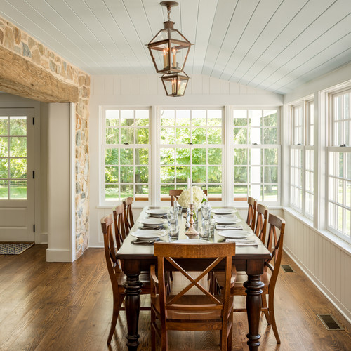Large cottage medium tone wood floor and brown floor enclosed dining room photo in Philadelphia with white walls and no fireplace  || Tips For Decorating A Dining Room On A Small Budget
