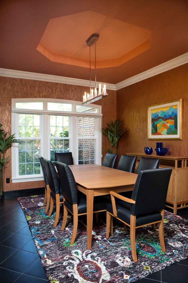 Large trendy ceramic tile and black floor enclosed dining room photo in Raleigh with brown walls and no fireplace