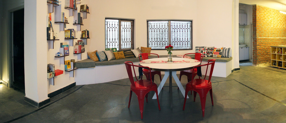 Photo of a large eclectic open plan dining room in Hyderabad with white walls, slate flooring and no fireplace.