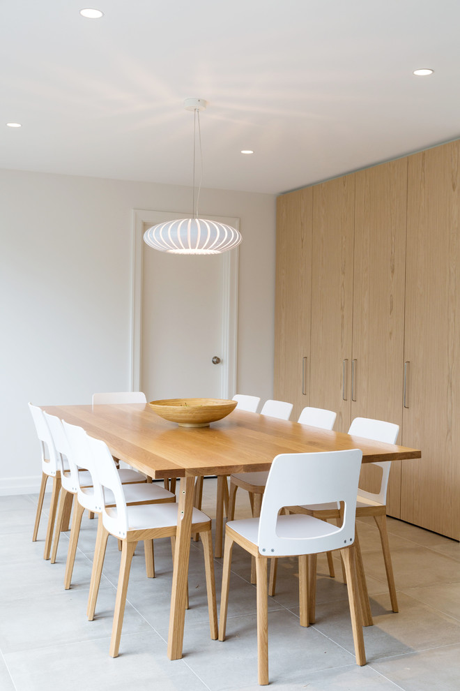 This is an example of a contemporary dining room in Melbourne with white walls.