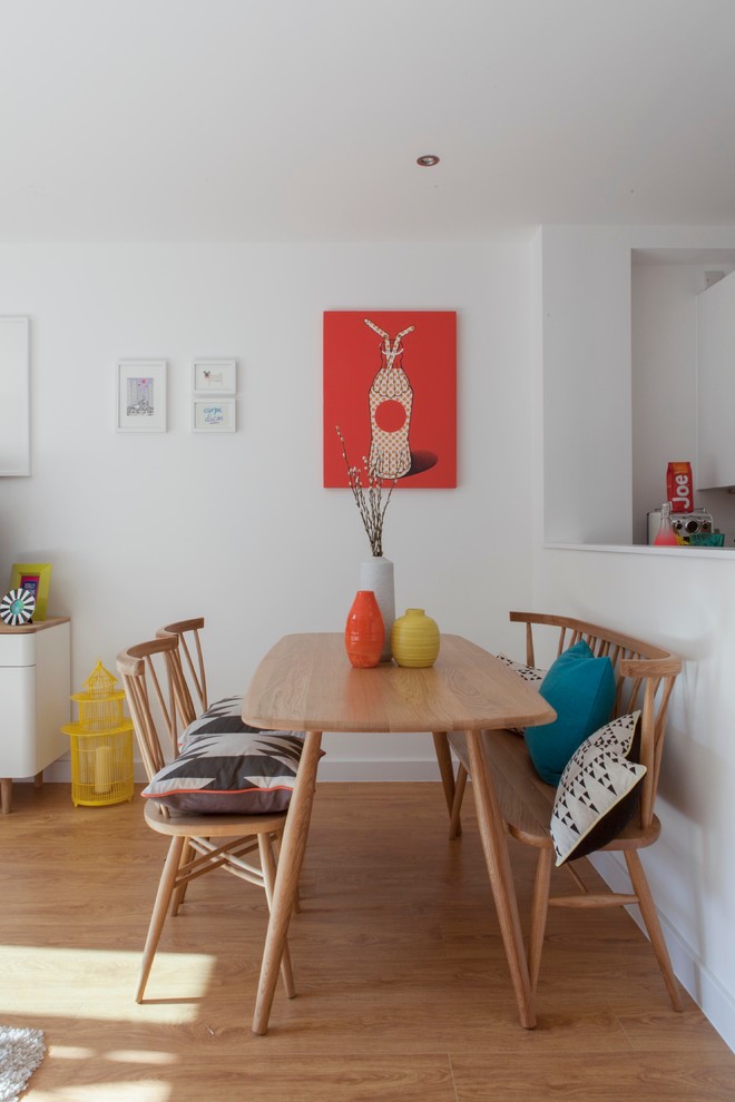 Photo of an eclectic open plan dining room in London.