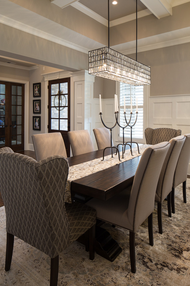 This is an example of a large traditional enclosed dining room in Atlanta with beige walls and dark hardwood flooring.