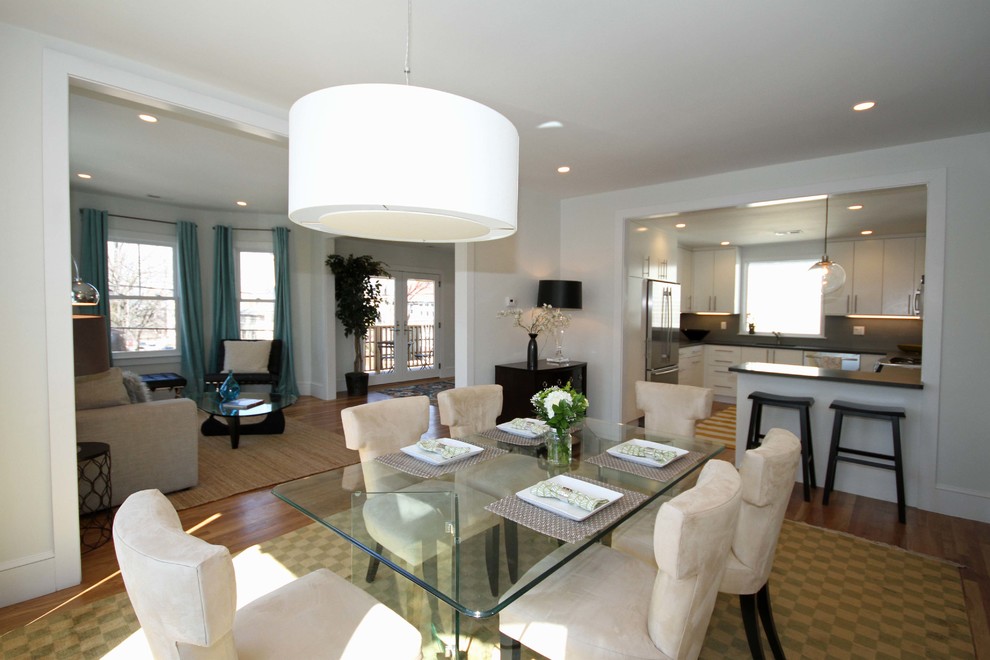 Photo of a large contemporary open plan dining room in Boston with white walls and medium hardwood flooring.