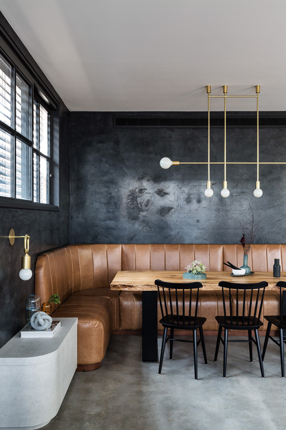 Industrial open plan dining room in Sydney with grey walls, concrete flooring and grey floors.
