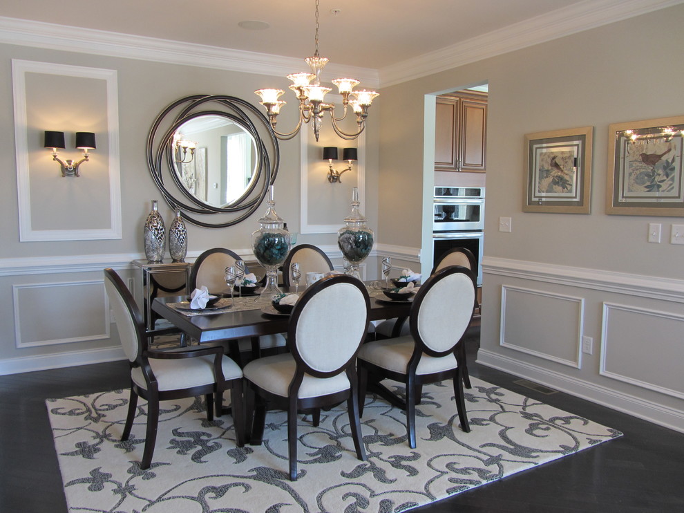 This is an example of a contemporary dining room in Boston with grey walls, brown floors and a dado rail.