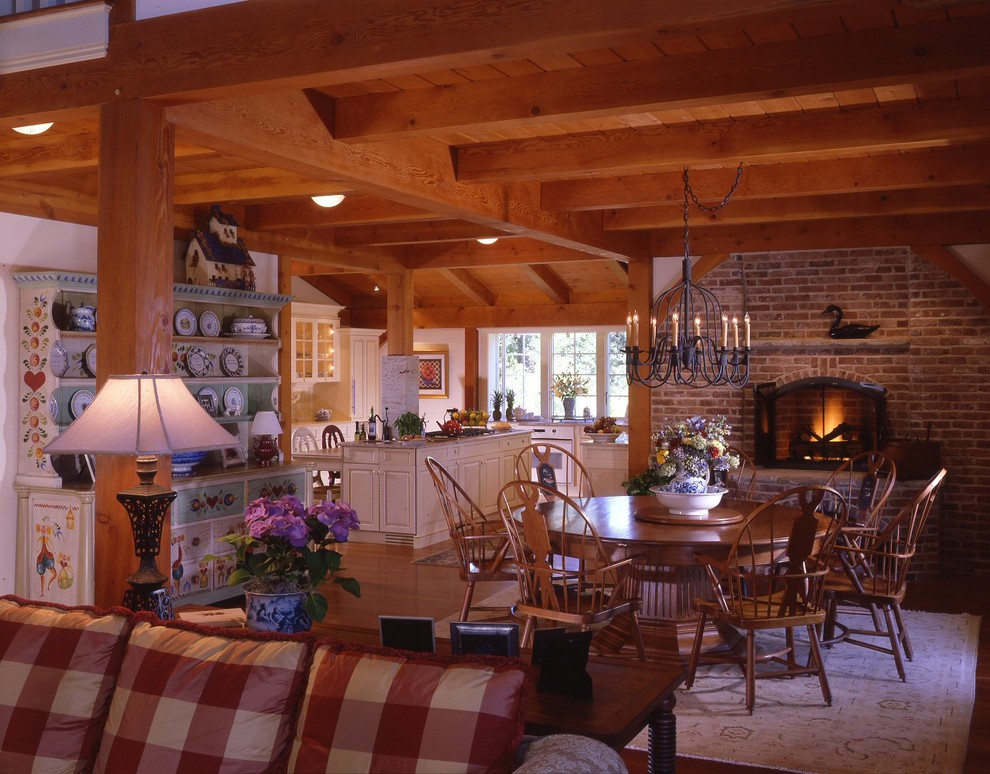 Foto de comedor de estilo americano abierto con paredes blancas, suelo de madera en tonos medios, todas las chimeneas y marco de chimenea de ladrillo