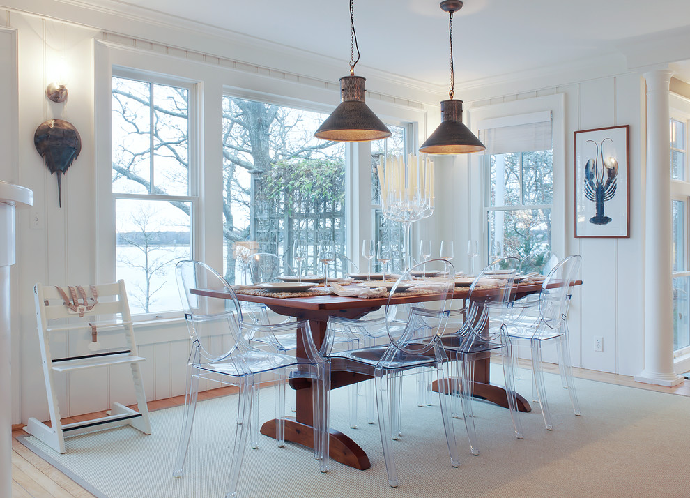 Photo of a beach style dining room in Boston with white walls and light hardwood flooring.
