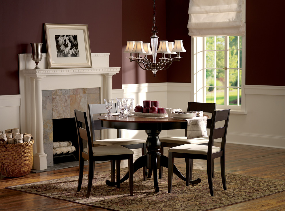 Dining room - traditional dark wood floor dining room idea in New York with red walls and a standard fireplace