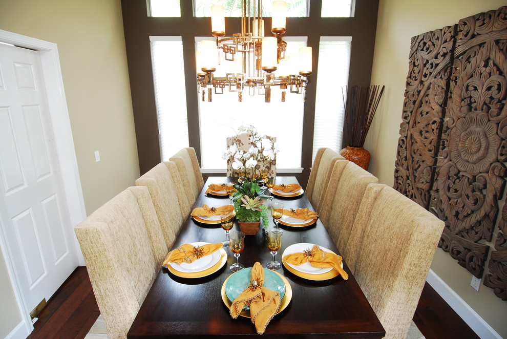 Photo of a world-inspired dining room in Orange County with beige walls and dark hardwood flooring.