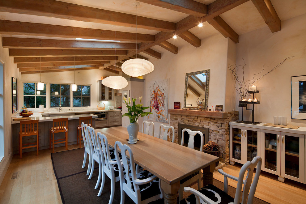 Cette photo montre une salle à manger tendance avec un manteau de cheminée en pierre.