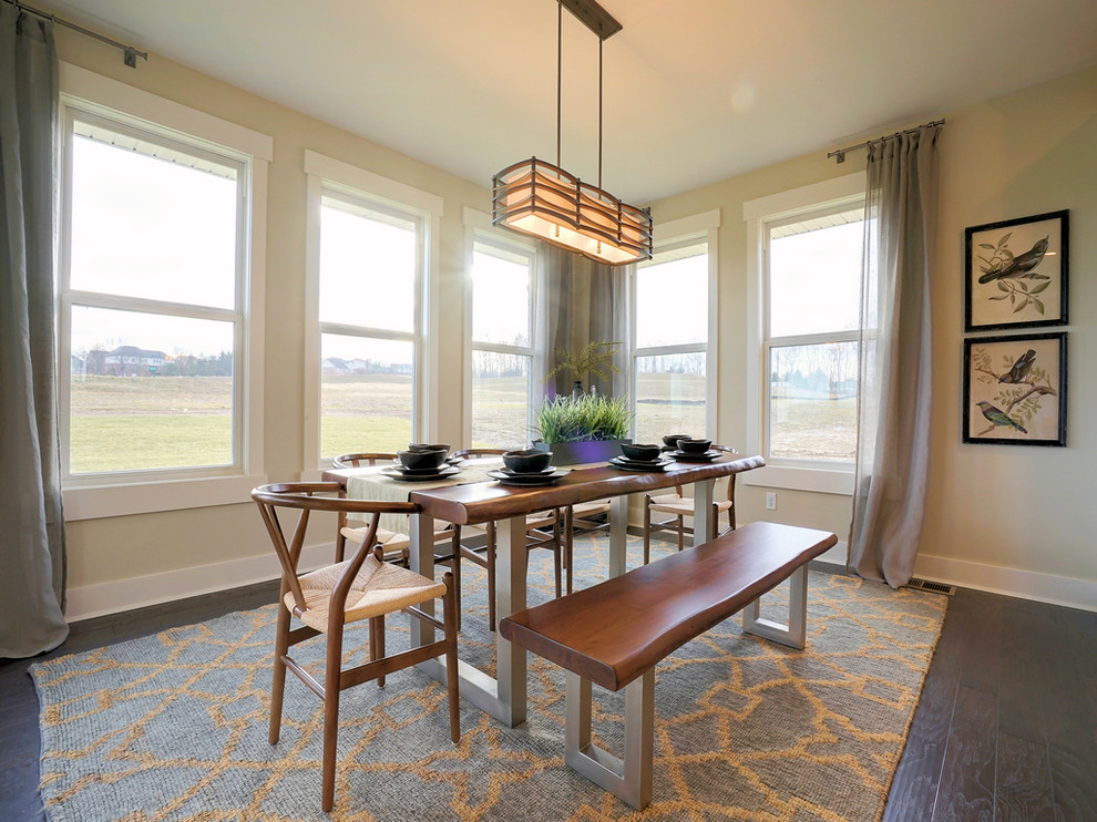 This is an example of a traditional open plan dining room in Cincinnati with grey walls, dark hardwood flooring and brown floors.