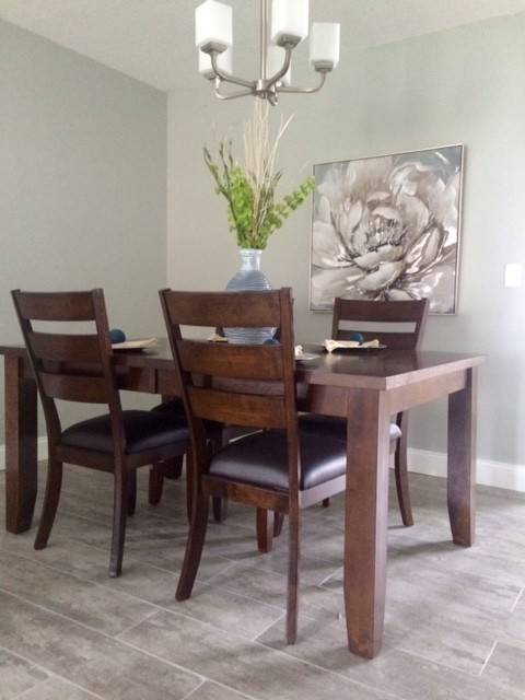 Photo of a medium sized contemporary dining room in Tampa with grey walls and light hardwood flooring.