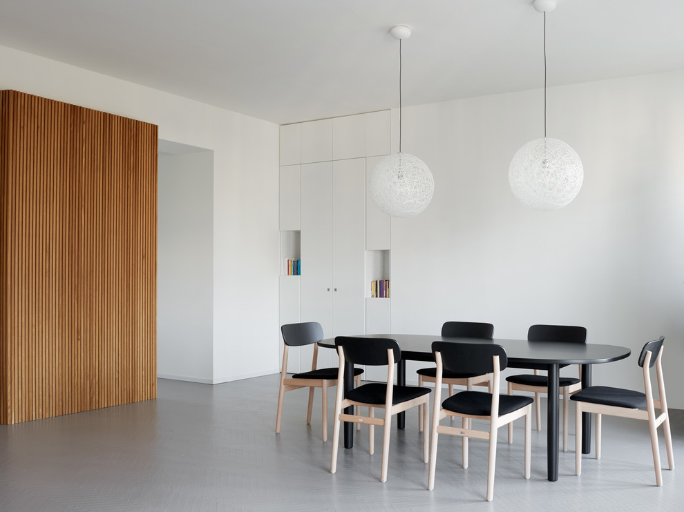 Contemporary dining room in Milan with white walls.