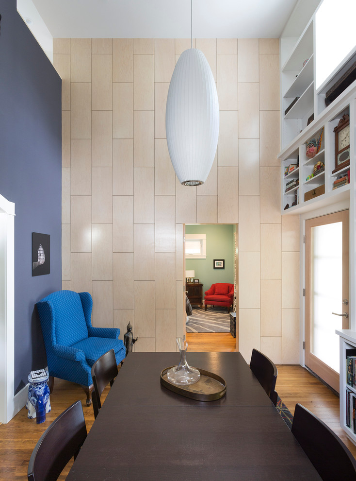 Inspiration for a small contemporary medium tone wood floor enclosed dining room remodel in Austin with blue walls
