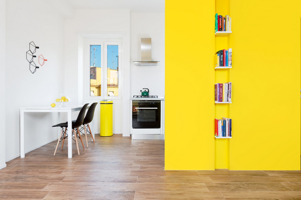 На фото: кухня-столовая в скандинавском стиле с желтыми стенами и светлым паркетным полом