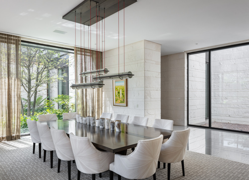 Photo of an expansive contemporary dining room in Austin with beige walls and grey floors.