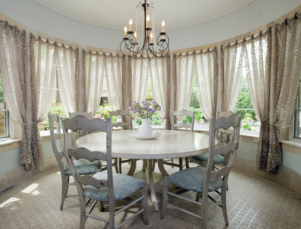 Example of a classic dining room design in Chicago with blue walls
