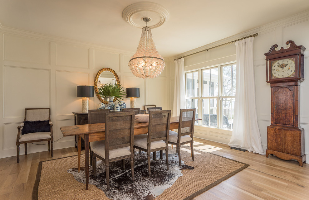 Classic dining room in Charleston with white walls, light hardwood flooring and beige floors.