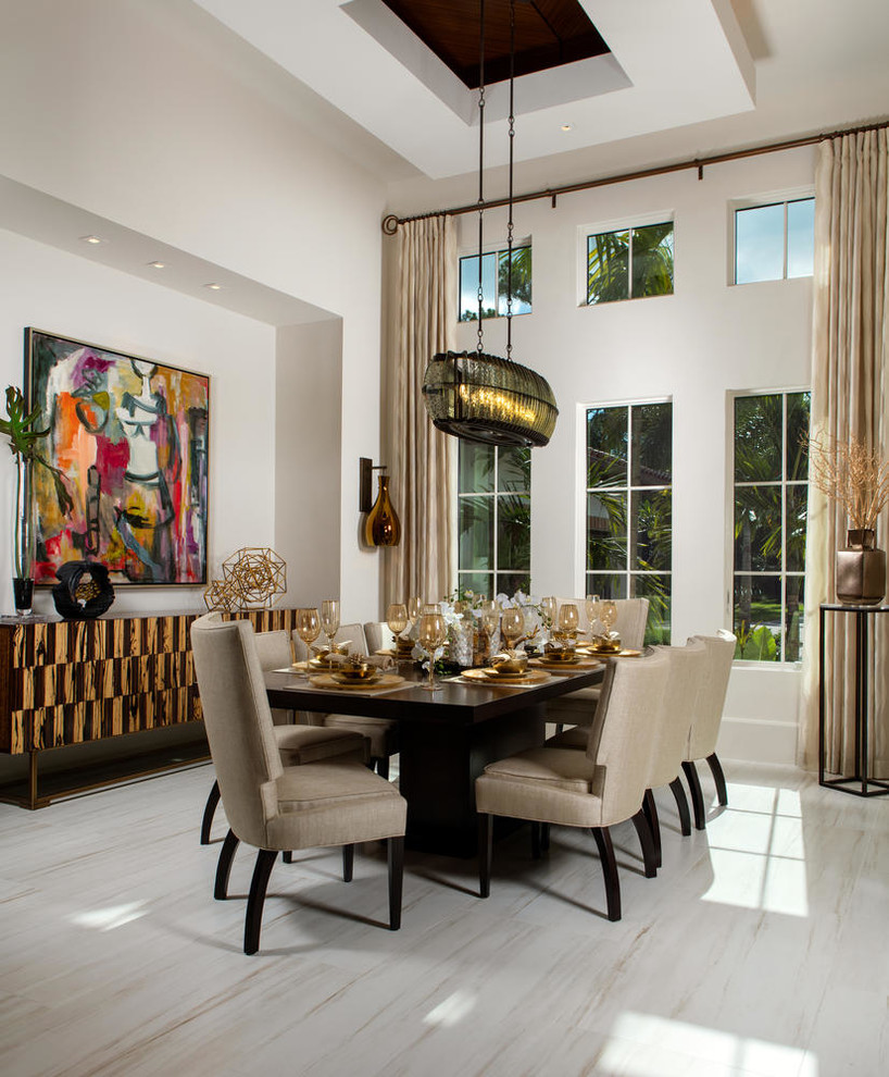 Mediterranean dining room in Miami with white walls.