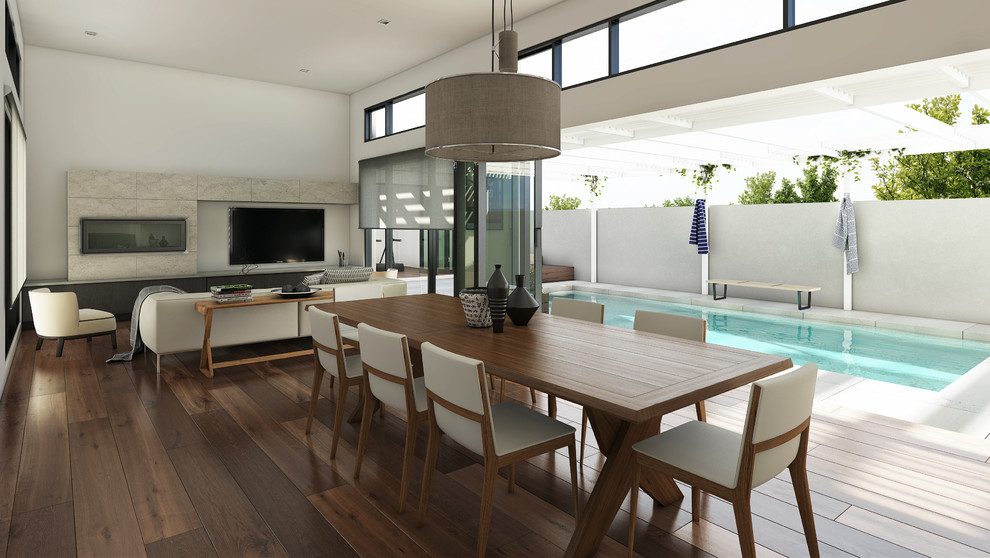 Große Moderne Wohnküche mit weißer Wandfarbe, braunem Holzboden, Kamin und gefliester Kaminumrandung in Melbourne