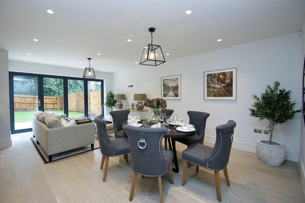Medium sized contemporary dining room in Buckinghamshire with white walls, light hardwood flooring and beige floors.