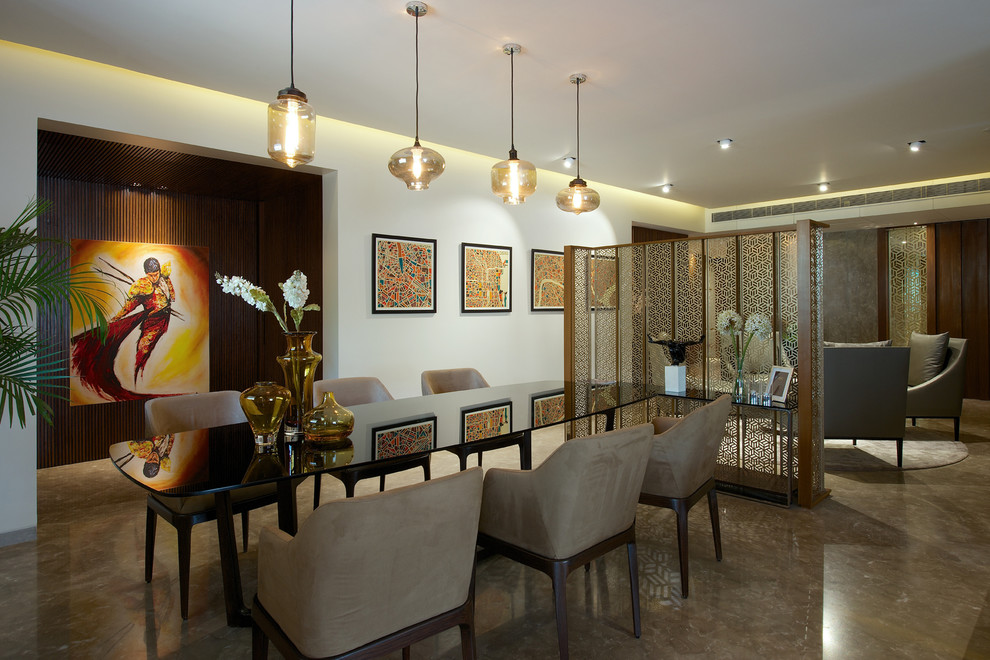 Contemporary dining room in Mumbai with white walls and brown floors.