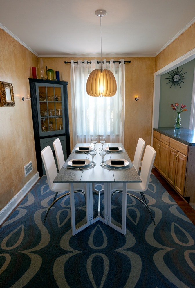 This is an example of a small modern kitchen/dining room in New York with metallic walls and carpet.