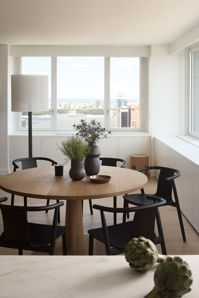Minimalist dining room photo in New York with white walls