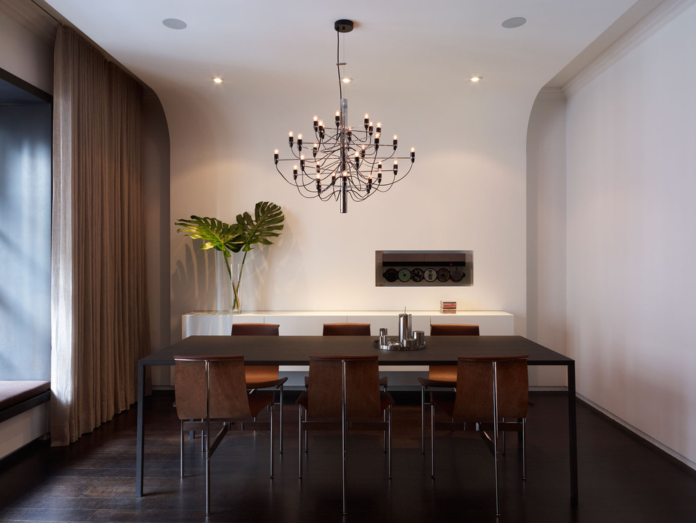 Minimalist dark wood floor dining room photo in New York with white walls