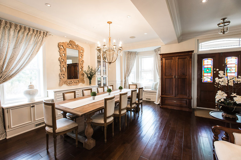 Rural enclosed dining room in Toronto with white walls and dark hardwood flooring.